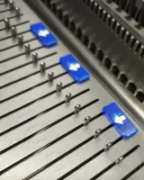 Blue needle markers marking needles on a 3gg needle bed