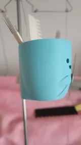 Blue cat-face organizer holding transfer tools, front view