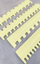 Yellow needle selector rulers, close-up of the needle slots