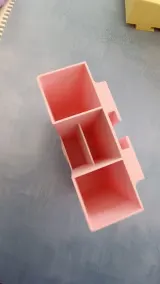 Pink tool organizer from above, showing three compartments