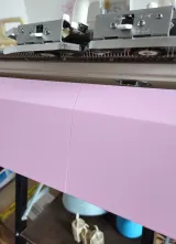 Pink lower front needle bed cover on a Brother 5gg machine